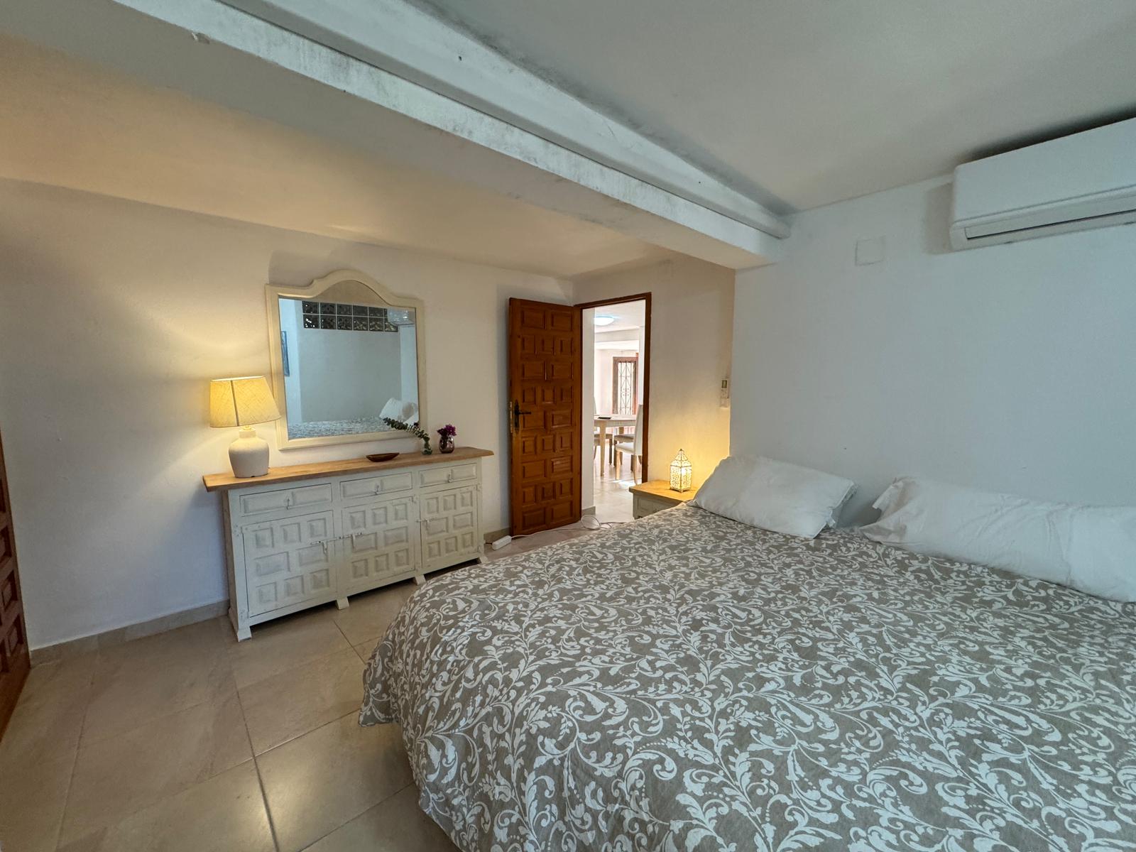 Double bedroom with patterned bedspread