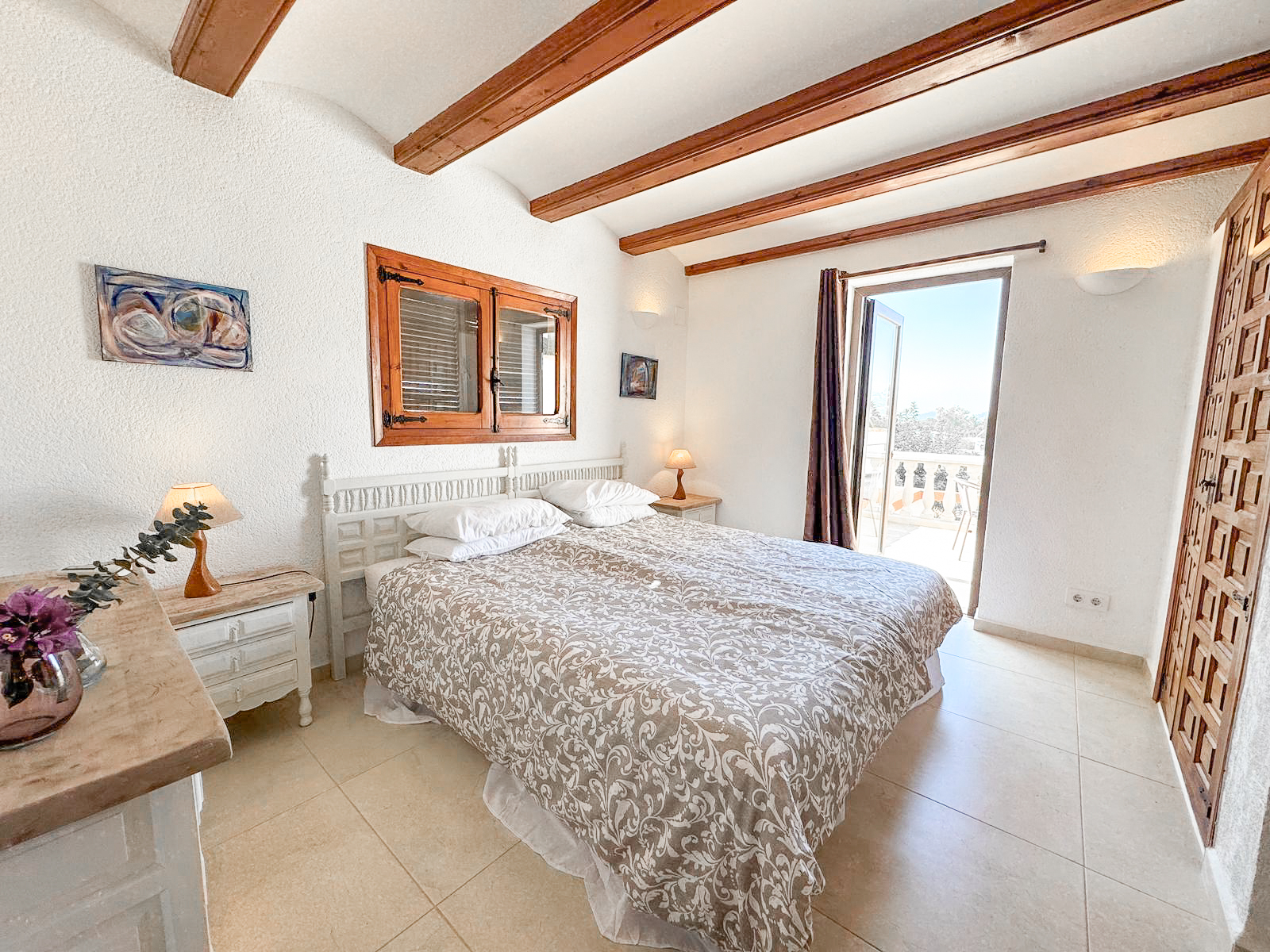 Bedroom 1 — king bed with terrace views at Villa Serena